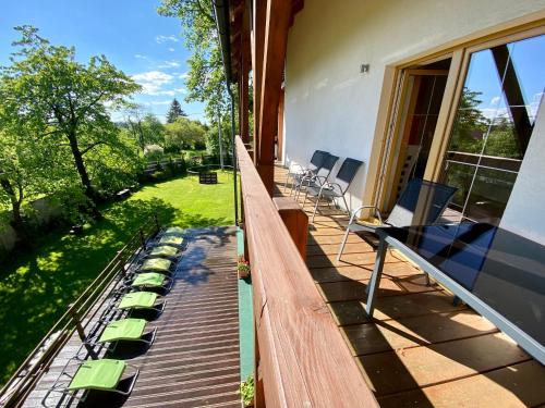 a deck with chairs and tables on a house at Penzion Patriot in Výprachtice