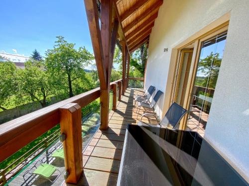 a balcony of a house with chairs on it at Penzion Patriot in Výprachtice