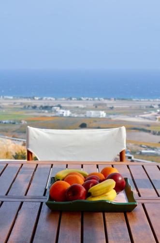 a tray of fruit sitting on a wooden table at Bluegonia in Éxo Goniá