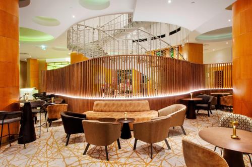 a lobby of a hotel with tables and chairs at The Westin Warsaw in Warsaw