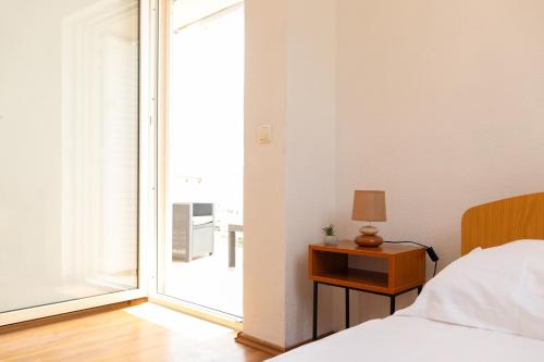 a bedroom with a bed and a large sliding glass door at Villa Pontem in Komarna