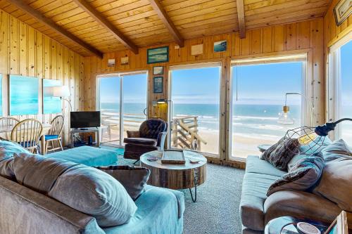 a living room with couches and a view of the ocean at Eagle's Bluff in Lincoln City