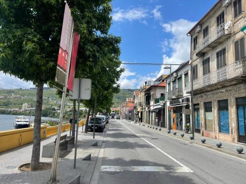 a street in a town with cars parked on the road at Cas'A Ferreirinha - Your Home In Douro in Peso da Régua
