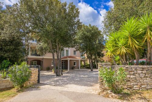 a house with a stone fence and trees at Villa Elizabeta in Pula