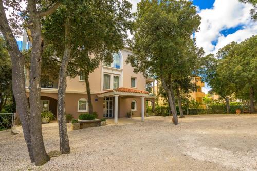 a large house with trees in front of it at Villa Elizabeta in Pula