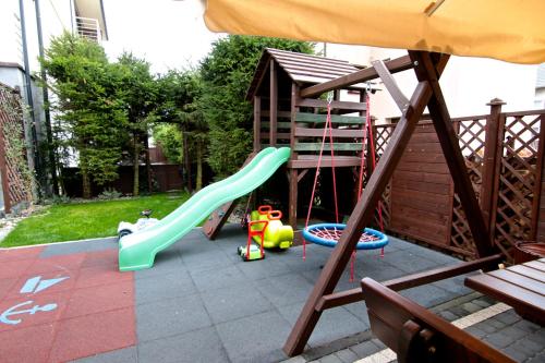 a small playground with a slide and a slide at Willa Sara Karwia in Karwia