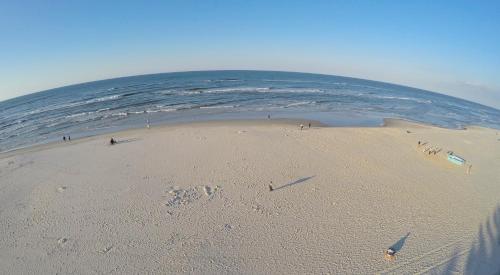 a group of people on a beach near the ocean at Willa Sara Karwia in Karwia