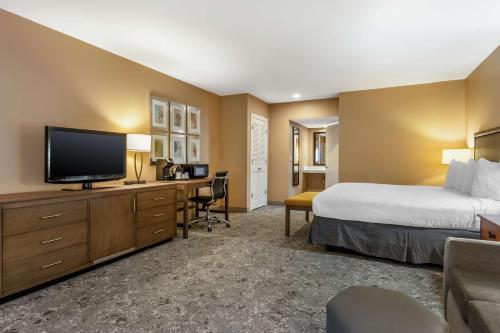 a hotel room with a bed and a flat screen tv at Best Western Plus Inn Scotts Valley in Scotts Valley