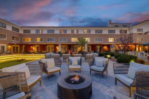 a courtyard with chairs and a fire pit in front of a building at Aiden by Best Western Scottsdale North in Scottsdale