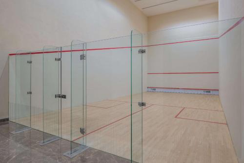 a room with a volleyball court with glass doors at Radisson Blu Hotel & Spa, Nashik in Nashik