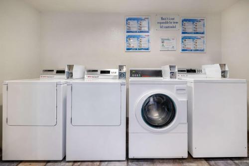 two washing machines and a washer and dryer in a room at Motel 6-Santa Ana, CA in Santa Ana