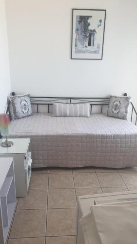 a room with a bed and a table and a couch at ERRIKA in Ermoupoli