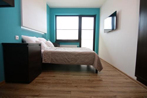 a bedroom with a bed and a window at Willa Sara Karwia in Karwia