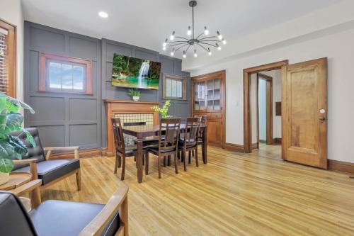a dining room and living room with a table and chairs at Updated 4BD House Near German Village w Parking in Columbus
