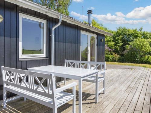 a white table and two benches on a deck at 6 person holiday home in Nykøbing M-By Traum in Alsted
