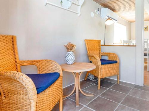 a dining room with wicker chairs and a table at 5 person holiday home in Karby-By Traum in Karby