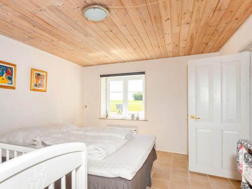 a bedroom with a bed and a wooden ceiling at 5 person holiday home in Karby-By Traum in Karby