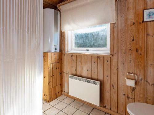 a bathroom with wooden walls and a window at Holiday home Thisted XXI in Sønder Vorupør