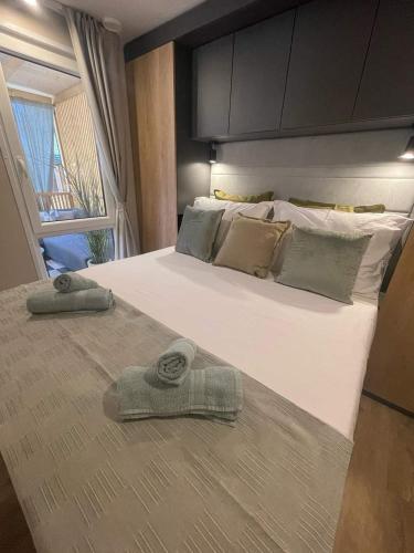 a bedroom with a large bed with two towels on it at Mobile Home Ivana in Biograd na Moru