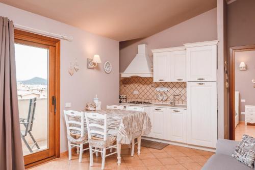 a kitchen and dining room with a table and chairs at OLBIA SKYVIEW ATTIC, Gaia's House in Olbia