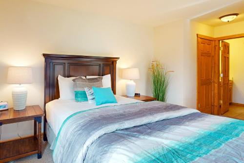a bedroom with a large bed with blue pillows at Lake Minocqua Lakeview in Minocqua