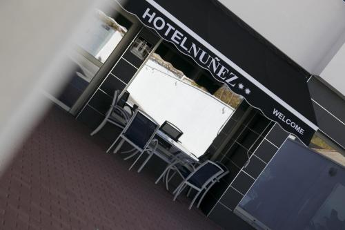 a restaurant with a table and chairs in front of it at Nuñez Tomelloso in Tomelloso