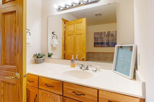 a bathroom with a sink and a large mirror at Lake Minocqua Lakeview in Minocqua