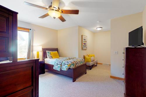 a bedroom with a bed and a ceiling fan at Lake Minocqua Lakeview in Minocqua