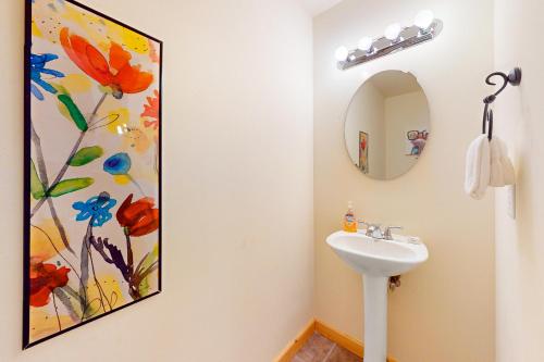 a bathroom with a sink and a painting on the wall at Lake Minocqua Lakeview in Minocqua