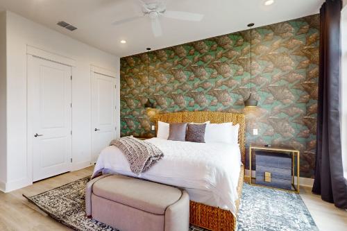 a bedroom with a bed and a stone wall at Mimosa Manor in Port Aransas