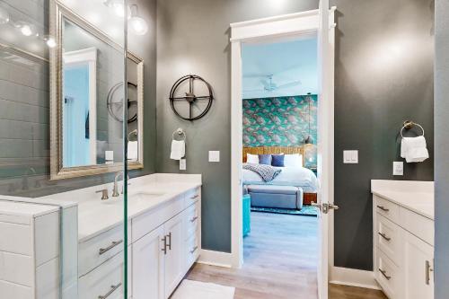 a bathroom with two sinks and a bedroom at Mimosa Manor in Port Aransas