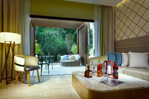 a living room with a couch and a table at TRS Yucatan Hotel - Adults Only in Akumal