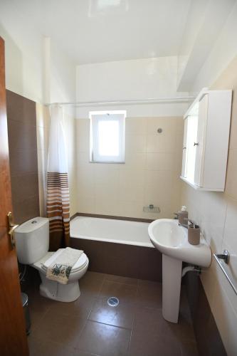 a bathroom with a tub and a toilet and a sink at Blue Serenity Apartment 5 in Ialysos