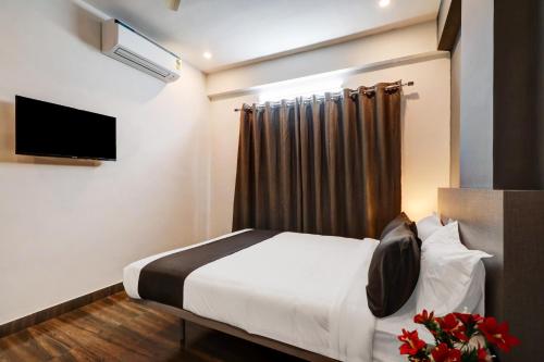 a hotel room with a bed and a television at Townhouse XOTEL in Bangalore