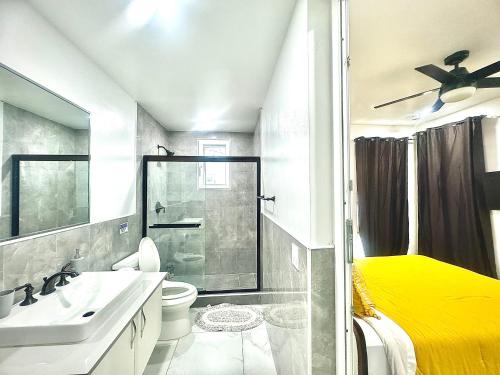 a bathroom with a sink toilet and a shower at Ocean Pearl - A brand new one bedroom with pool, walkable distance to sunset beach in Long Bay Hills