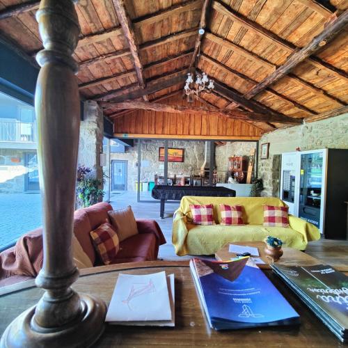 a living room with a table and a couch at Quinta da Alqueidosa - Casa de Campo in Guarda