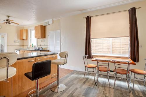 a kitchen with a table and chairs in a room at North Denes Villa in Great Yarmouth
