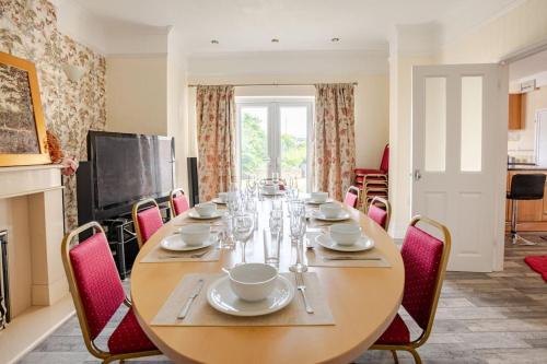 a dining room with a wooden table and chairs at North Denes Villa in Great Yarmouth