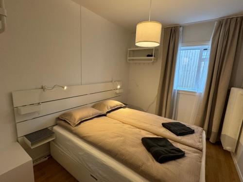 a bedroom with a large bed with two pillows on it at Central Pearl Apartment in Reykjavík