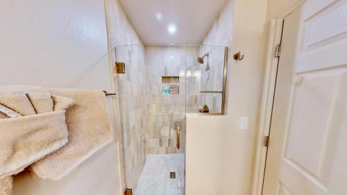 a shower with a glass door in a bathroom at Henning's Escape #3328 in Moab