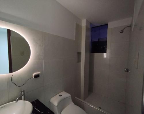 a bathroom with a toilet and a sink and a shower at ALPHA69 in Cajamarca