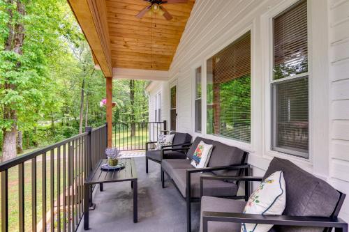 a porch with chairs and a wooden ceiling at 3 Mi to Downtown Home with Fire Pit in Forest City in Forest City