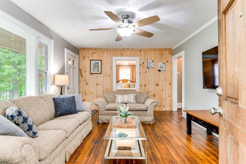 a living room with a couch and a table at 3 Mi to Downtown Home with Fire Pit in Forest City in Forest City
