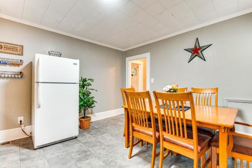 a dining room with a table and a refrigerator at 3 Mi to Downtown Home with Fire Pit in Forest City in Forest City