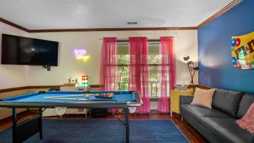 a living room with a ping pong table at 4bd Contemporary Home with BBQ, Game Room in Charlotte