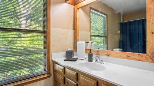 a bathroom with a sink and a mirror at 4bd Contemporary Home with BBQ, Game Room in Charlotte