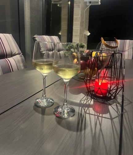 two glasses of white wine sitting on a table at Villa Sunset Yerakini in Poligiros