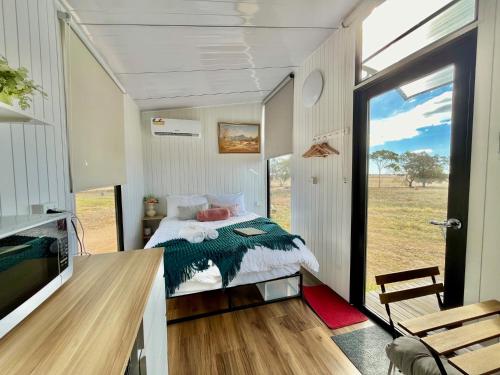 a bedroom in a tiny house with a bed at Avondale Heights 