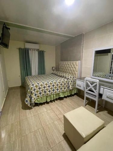 a bedroom with two beds and a sink and a mirror at Hotel Frano Romana Center in La Romana
