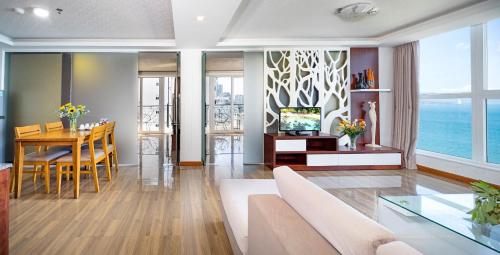 a living room with a couch and a table at Paris Luxury Hotel & Apartment Nha Trang in Nha Trang